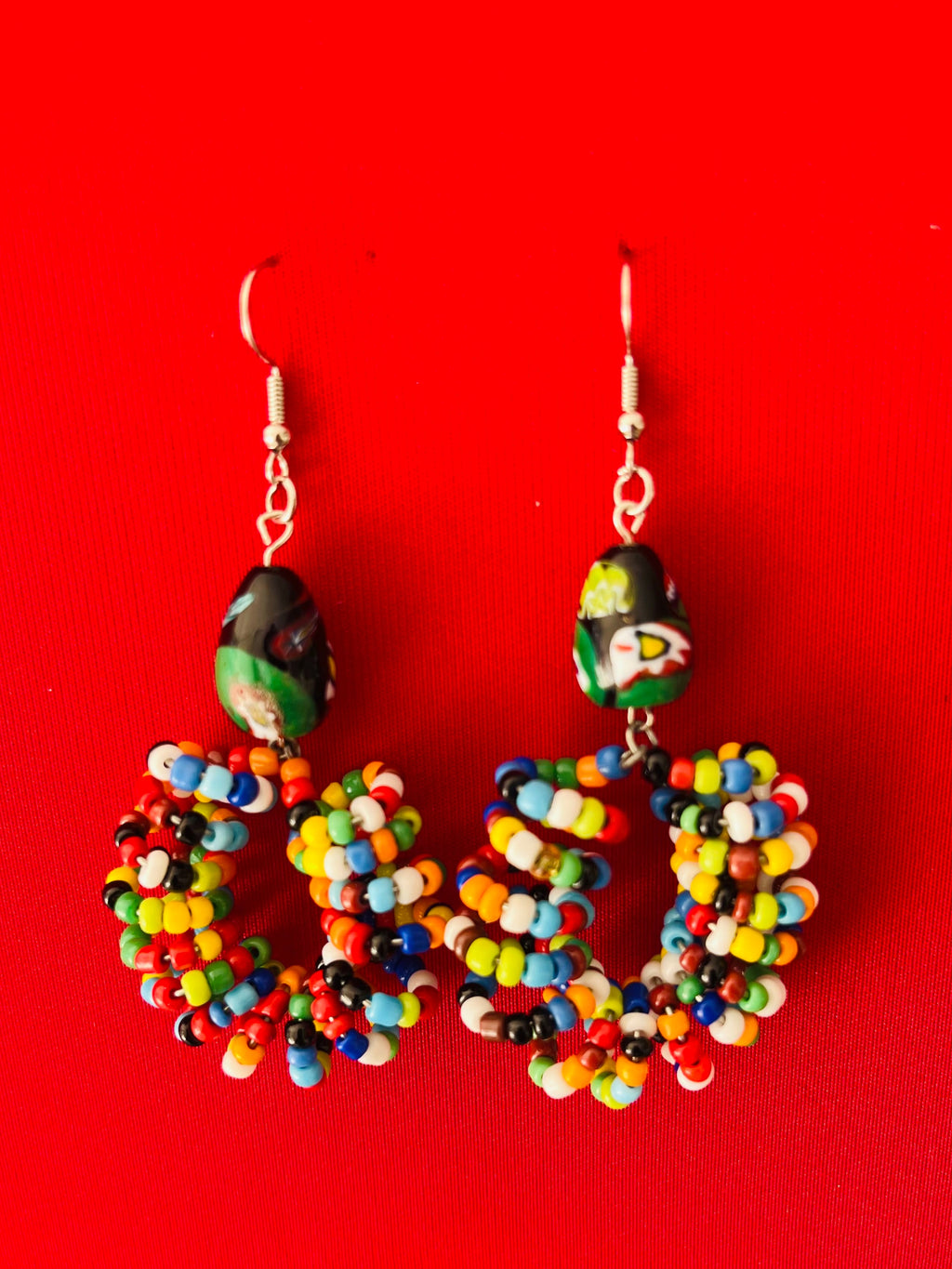 Beaded earrings with vibrant colours and a hand-formed design, each pair uniquely made